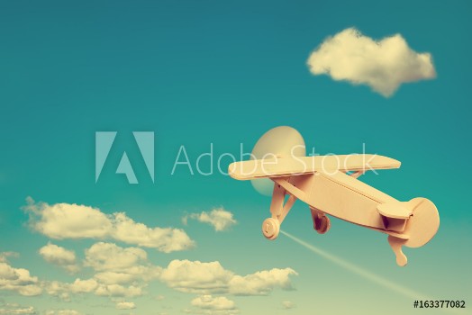 Picture of Wooden plane flying in the sky